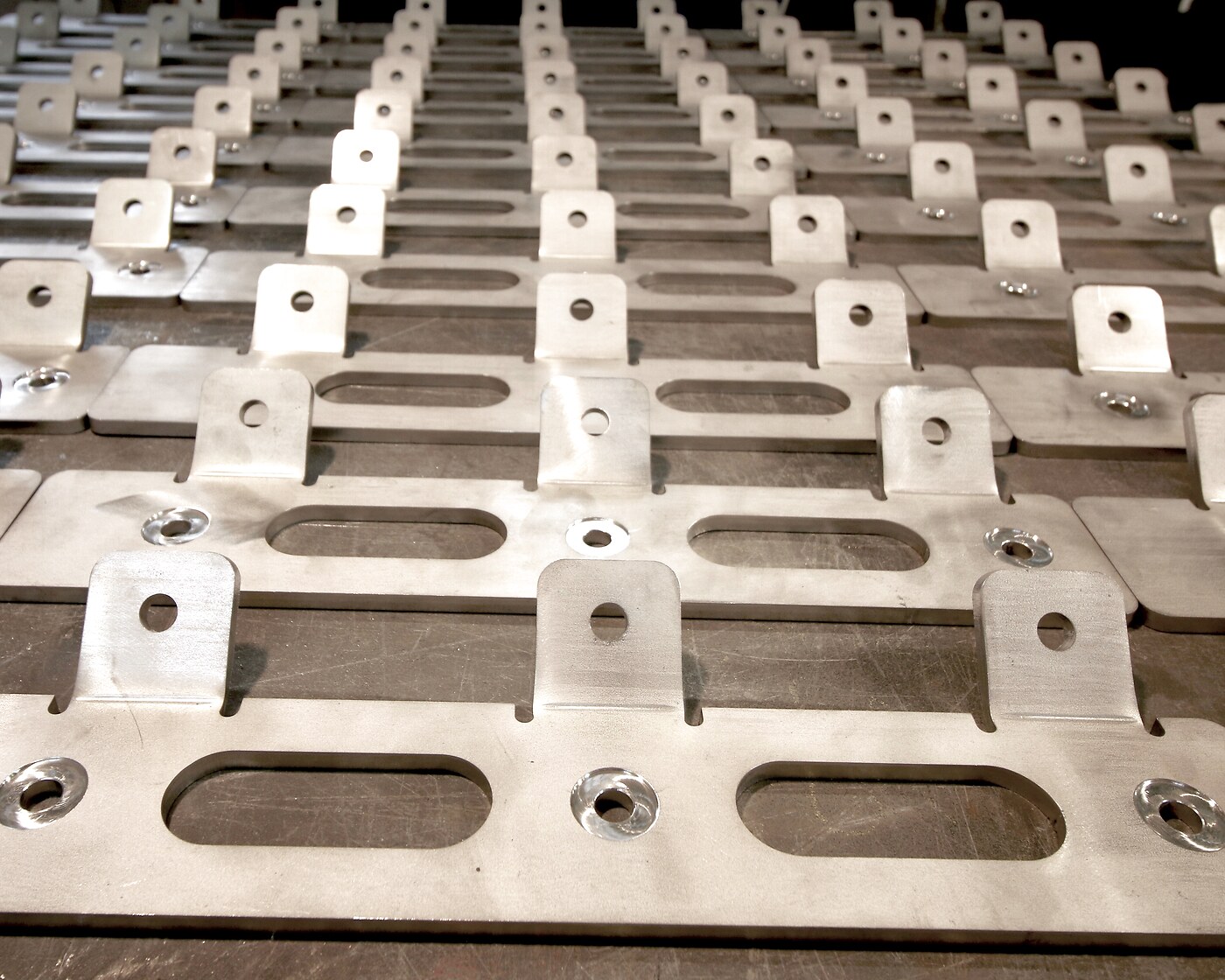 Serial bent brackets with slotted holes